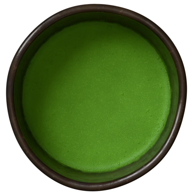 The black tea bowl from this page, whisked to a green foam, seen from above.