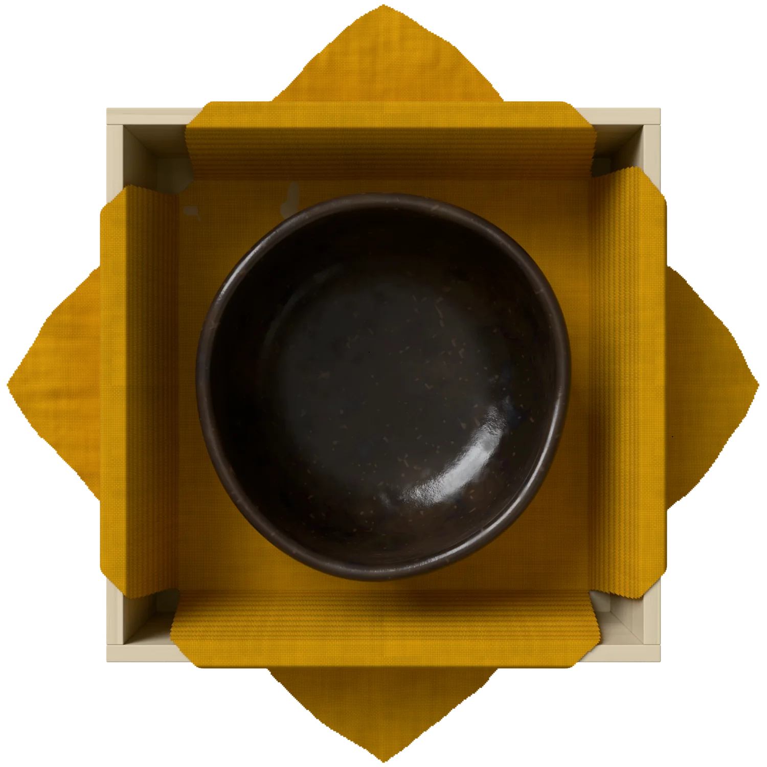 The open box: yellow cloth folded back over its walls, a black raku tea bowl inside, seen from above.